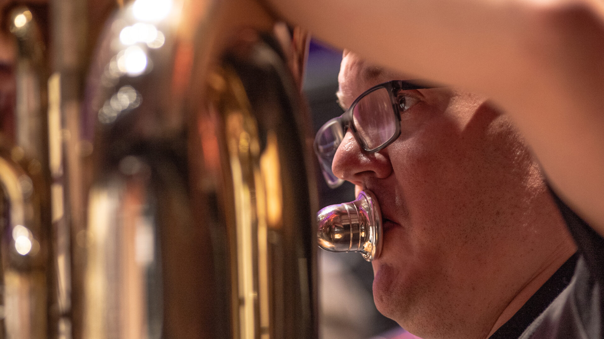 A talented BSO musician passionately playing a brass horn
