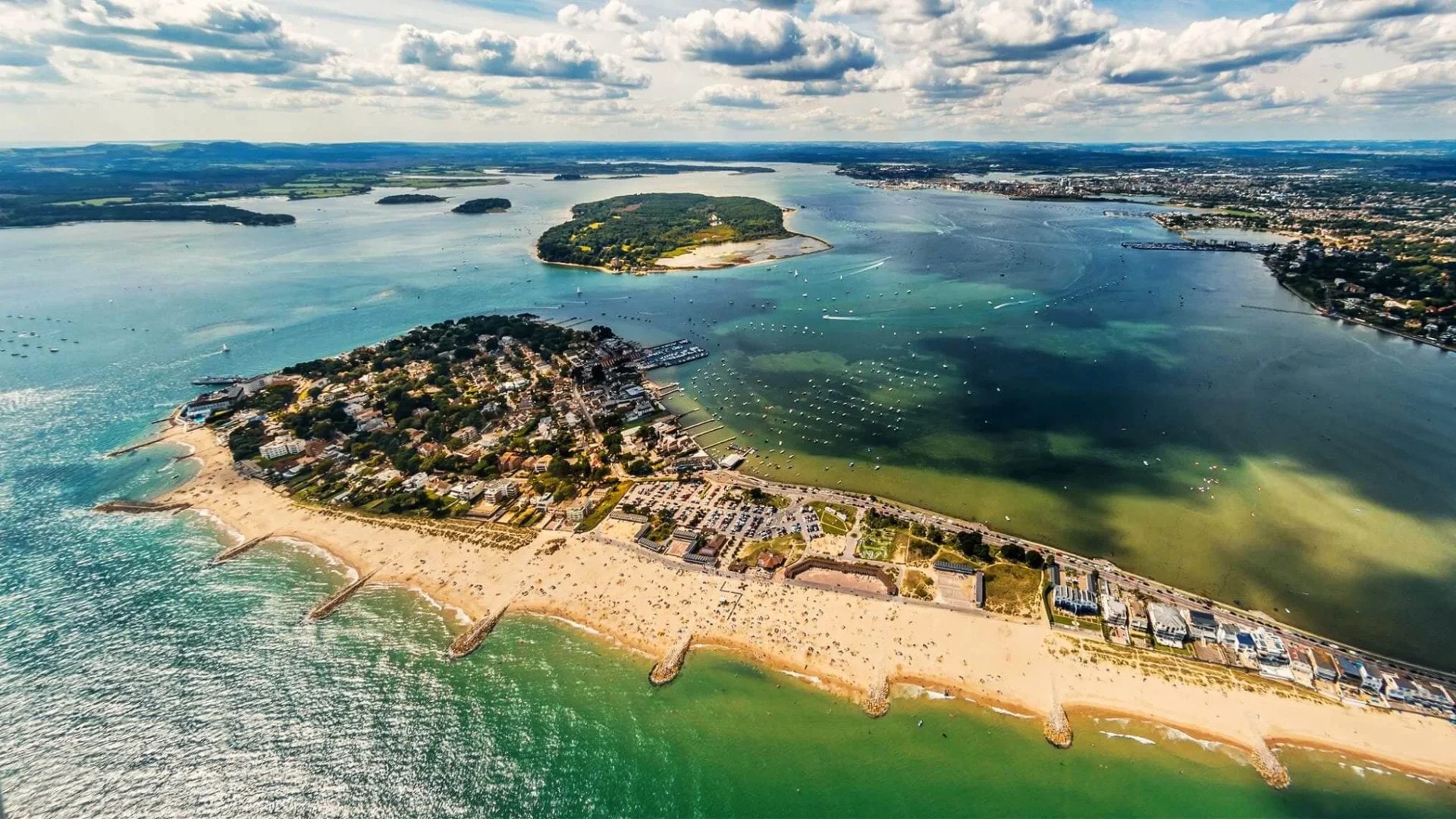 Aerial photo of Sandbanks, Dorset with sandy beaches and islands in Poole Harbour.