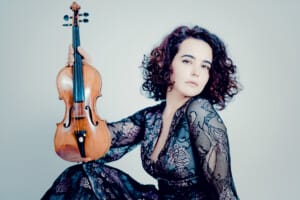 Violinist Alena Baeva sits with her violin